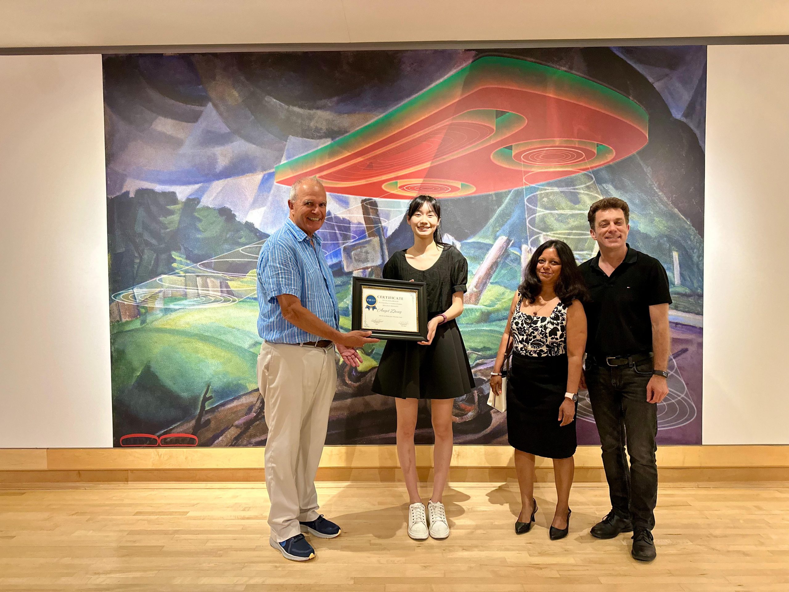 Angel Zheng is presented with the Wallace Joyce Scholarship award by Varley-McKay Art Foundation of Markham board members, at the Varley Art Gallery. From left to right: Chair Jim Schmidt, Angel Zheng, Arpita Surana, and Vice-Chair Craig McOuat. All stand in front of Sonny Assu, The Away Team Beams Down to What Appears to Be an Uninhabited Planet, 2016, digital intervention on an Emily Carr painting (Vanquished, 1930), archival pigment print, 55.8 cm x 83.8 cm.)