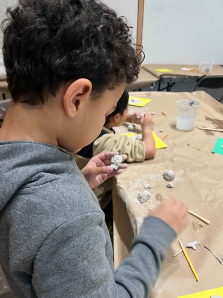 Young students using clay